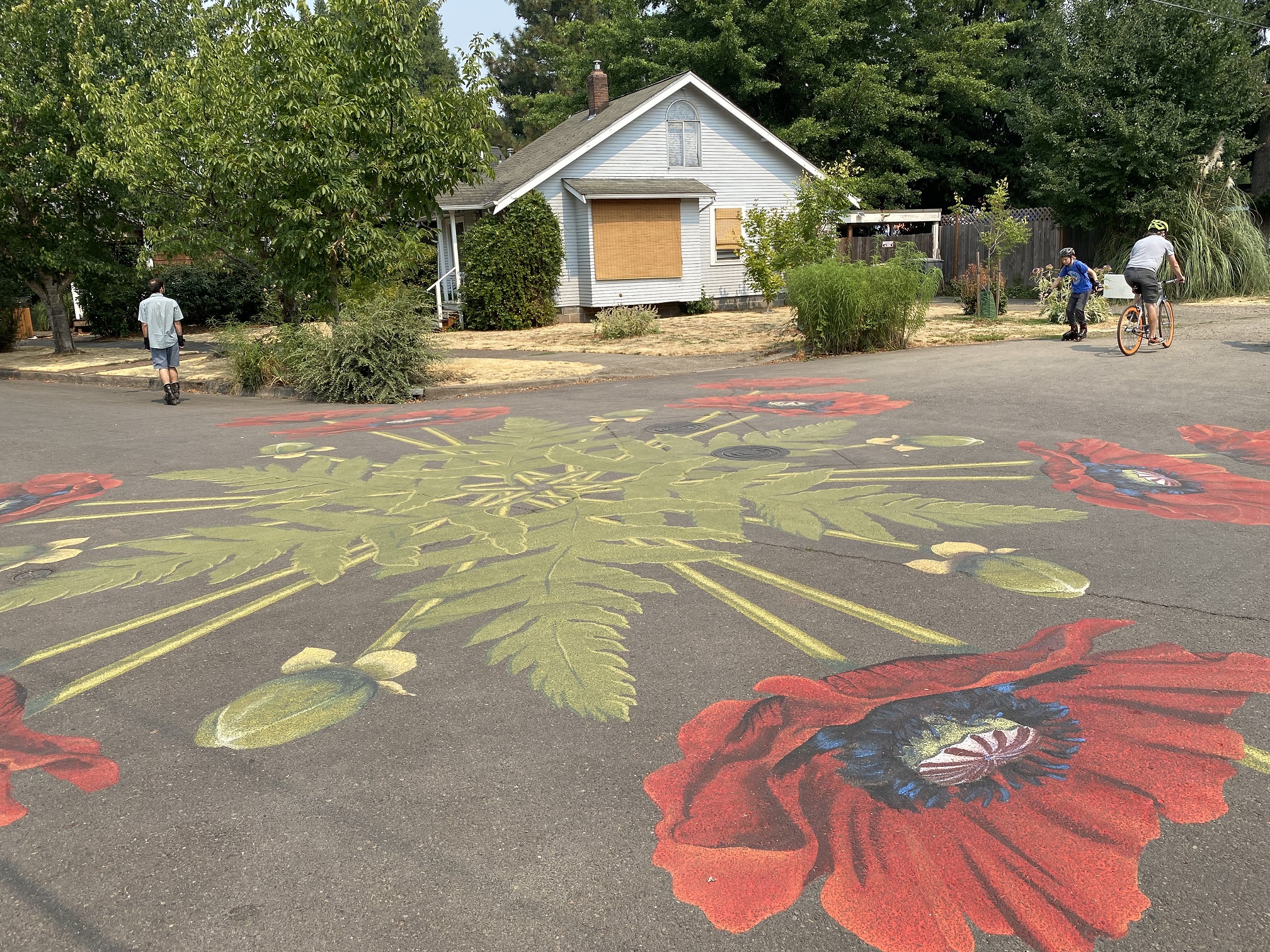 A street mural of poppies radiating out from a center point.